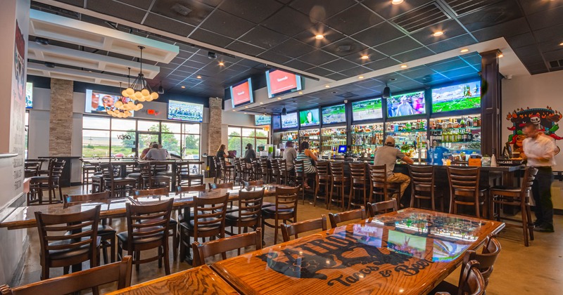 Interior, bar and dining area with guests and staff