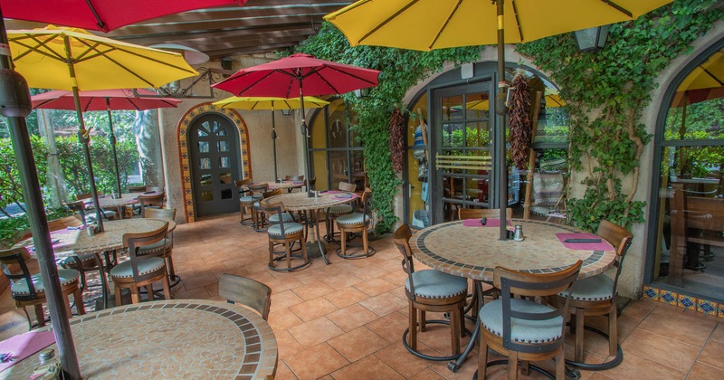 Exterior seating area with chairs, tables and parasols