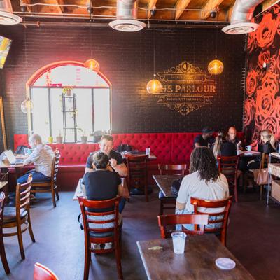 Interior featuring a distinct red booth seating area against a dark wall.
