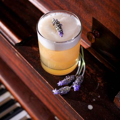 Whiskey Sour with lavender garnish.