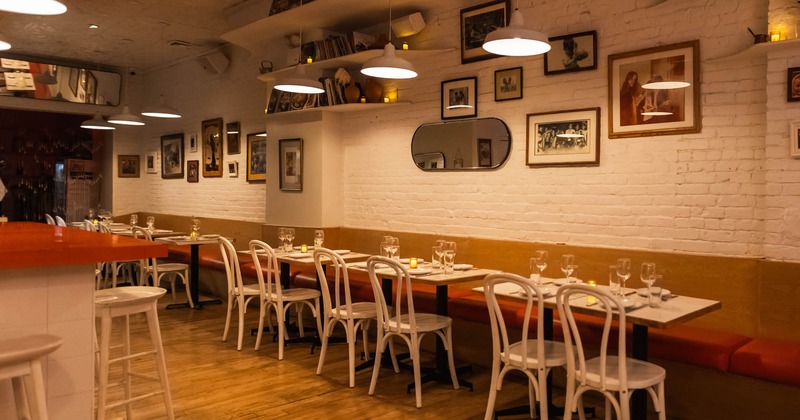 Dining area, tables ready for guests, pictures on the wall