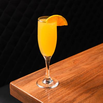 Mimosa with orange slice garnish.