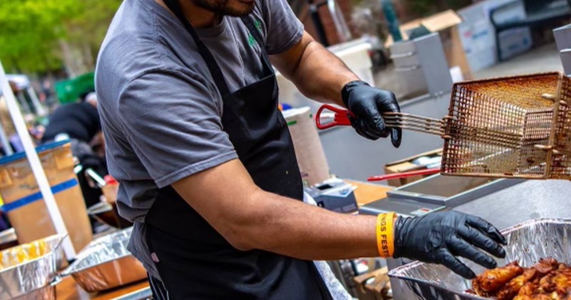 Employee frying chicken wings