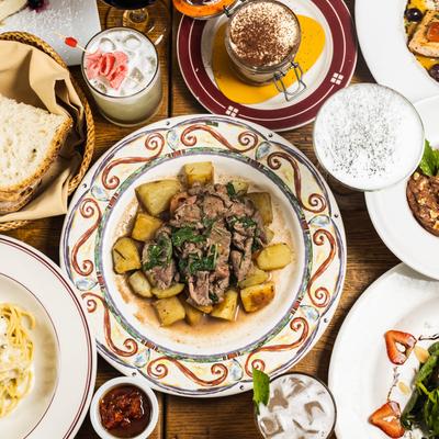 Assortment of dishes and drinks spread on a table, overhead view.