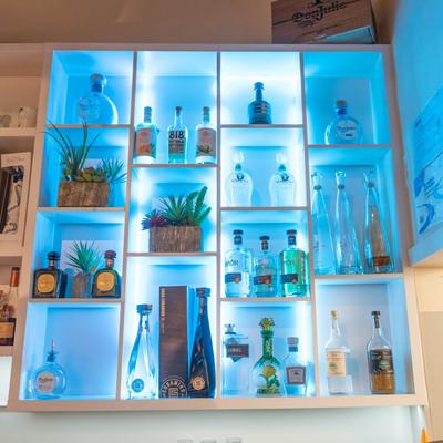 Bar area, drink on shelf with neon light behind