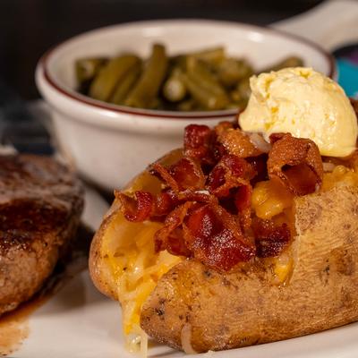 Grilled beef tenderloin served with loaded baked potato and green beans.