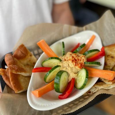Hummus served with red peppers, carrots, cucumber and pita