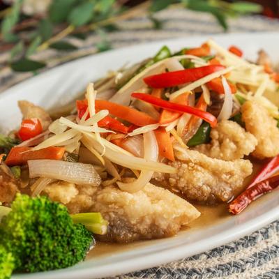 Fried grouper tipped with ginger, scallions, carrot, and mushrooms.
