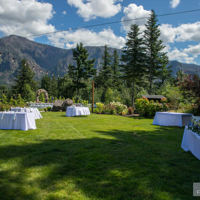 View of restaurant grass area with tables setup
