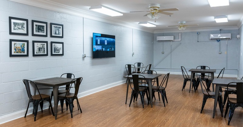 Seating area, TV screen, and pictures on the wall