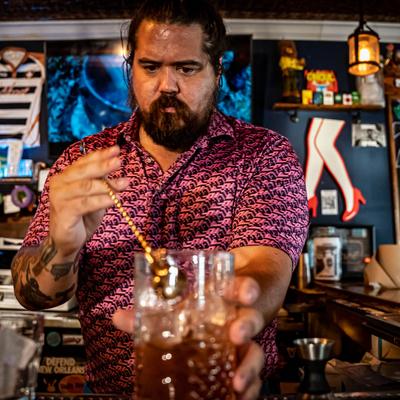 A bartender fixing a drink