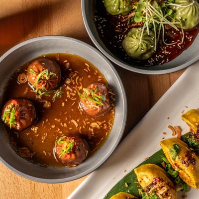 Kobe Beef Dumplings served alongside Veggie Dumplings and a plate of gyoza.