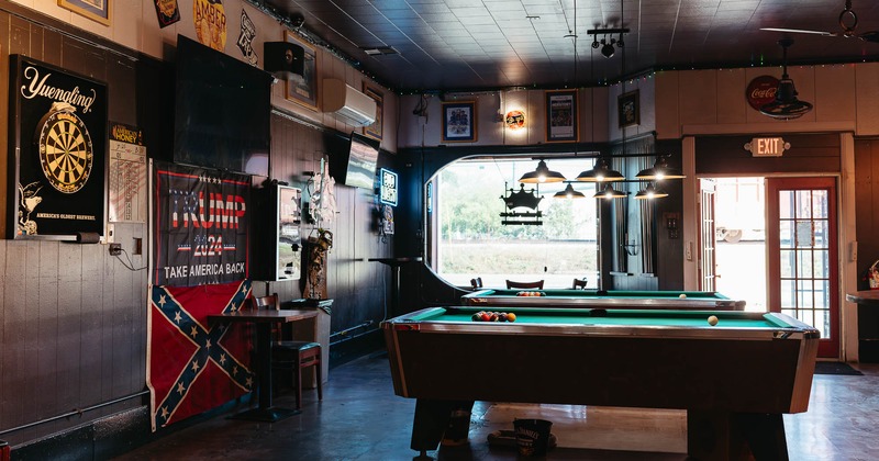 Interior, pool tables with large window in the back