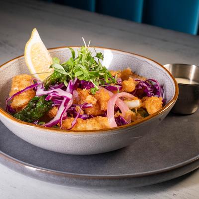 Crispy calamari, with shishito peppers, cabbage, and lemon ginger aioli.