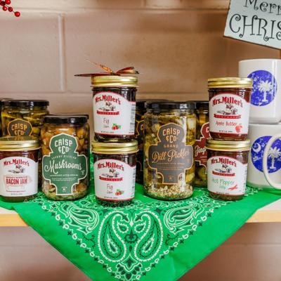 Assorted jars of jams, pickles, and preserves on display.