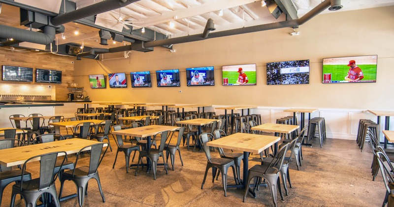 Interior, seating area with a tap beer bar and wall TVs