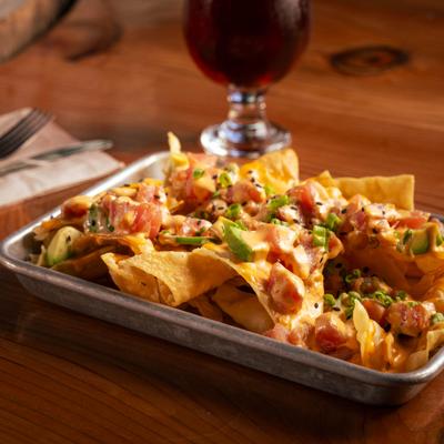 Tuna poke nachos with a glass of beer.