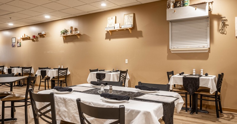 Interior, tables and chairs in dining area