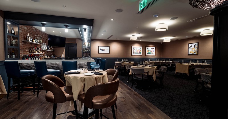 Restaurant interior with a bar, tables, and chairs