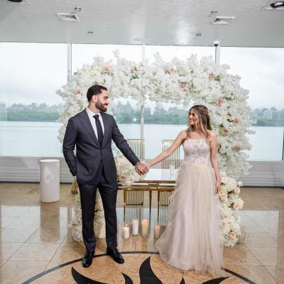 Newlywed couple holding hands.