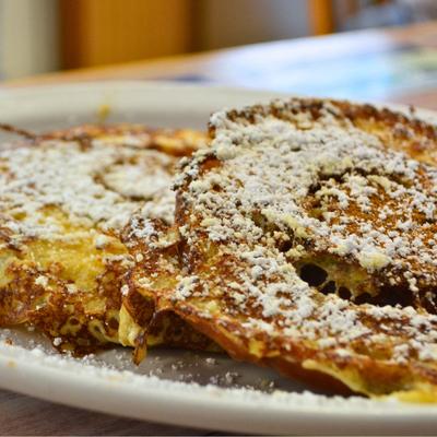 Cinnamon rolls covered with powdered sugar.
