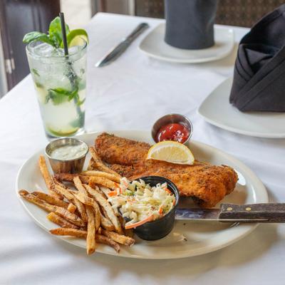 Fried haddock, with fries, coleslaw, and dipping sauces.
