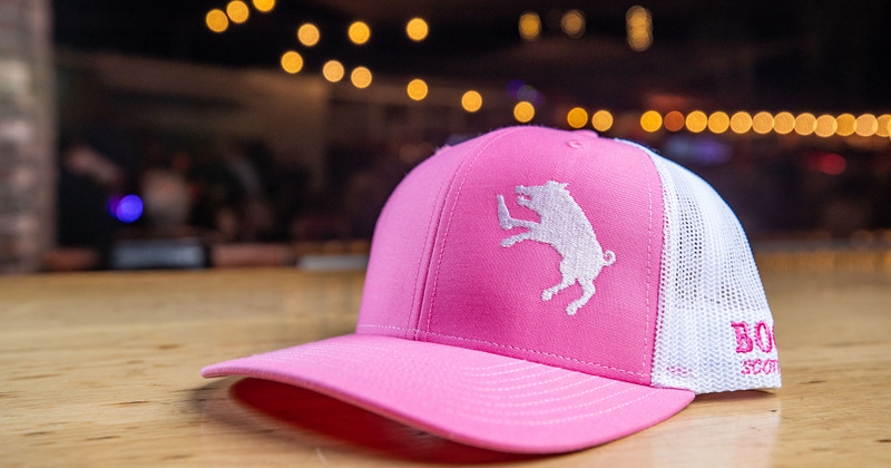 Two employees standing behind the bar