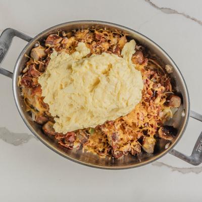 Meat lovers skillet with eggs and potatoes.