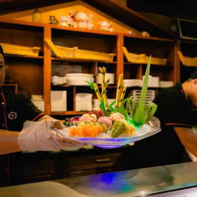 Chef presents a Sushi Deluxe plate.