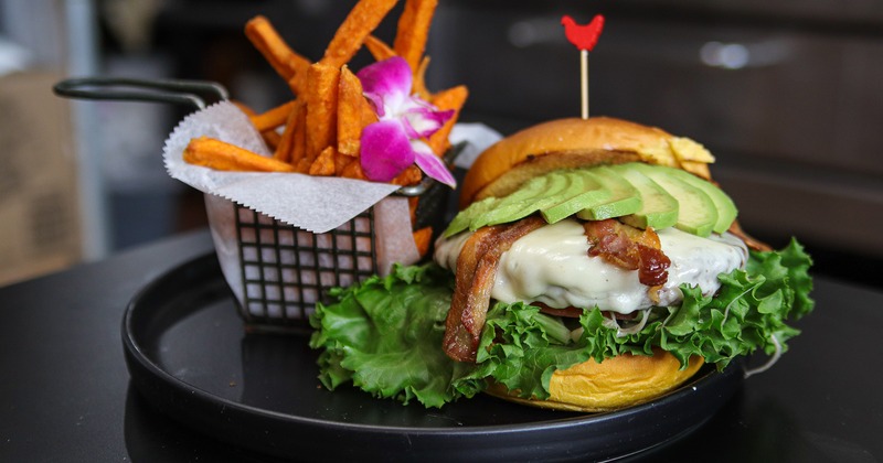 A served avocado BLT Burger, side view