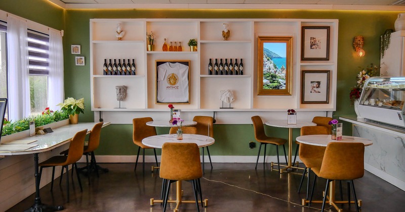 Interior, tables and chairs with countertop with pastry on the right side
