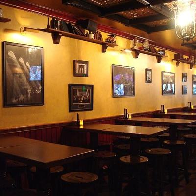 Interior with yellow walls, tables, chairs, and wall art.