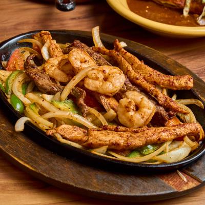 Mixed fajitas with steak, chicken, and shrimp.