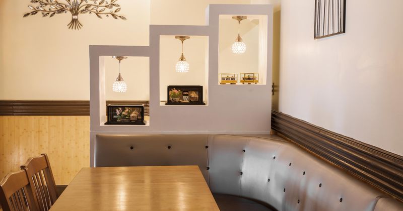 a corner booth with light fixtures and decoration