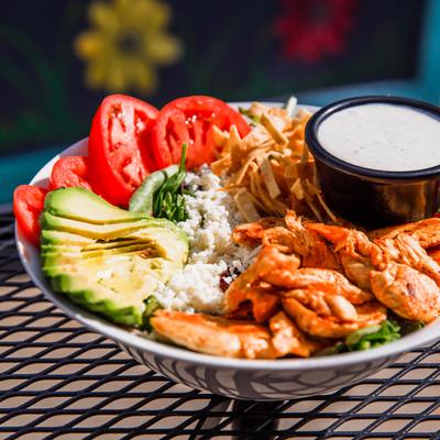 Chicken Avocado Salad, with mixed greens, tomato, cheese, tortilla strips, and ranch dressing.