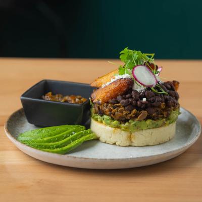 Cornmeal cakes served with shredded beef, salsas, black beans, sweet plantains and cheese.