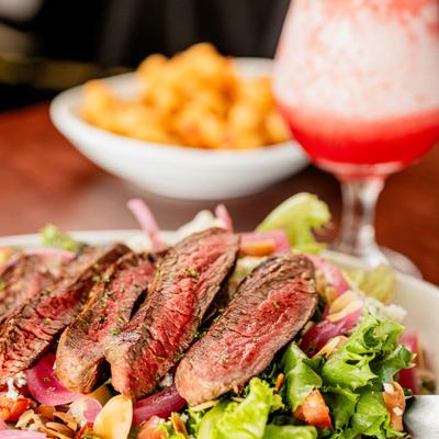 Steak salad with mixed greens and vegetables.