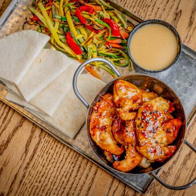 Kung Pao Wraps served with mandolin vegetables, tortillas, and honey ginger sauce.