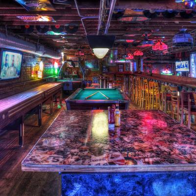 Interior with a pool table, shuffleboard, and sports-themed decor.