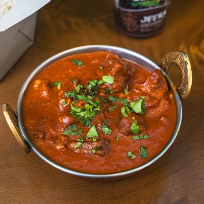 Indian lamb curry in a metal bowl.