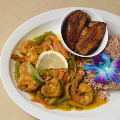 Curry shrimp served with rice and peas, and plantains.