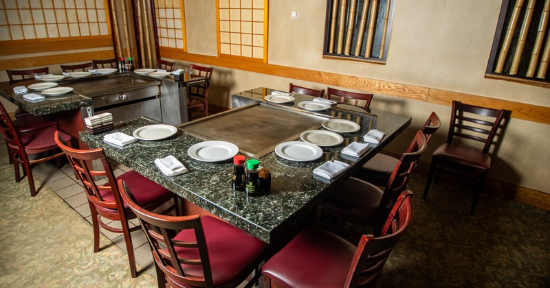 Interior, marble top hibachi tables with padded chairs for seven people