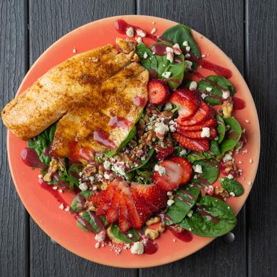 Salad with strawberries, spinach, blue cheese, walnuts, and raspberry vinaigrette.