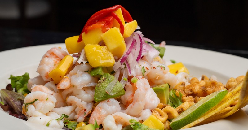 Seasonal Shrimp Ceviche topped with red onion and sweet mango