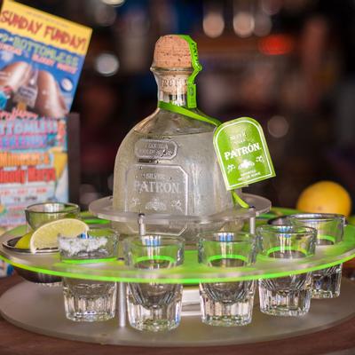 Tequila bottle with a flight of tequila shots