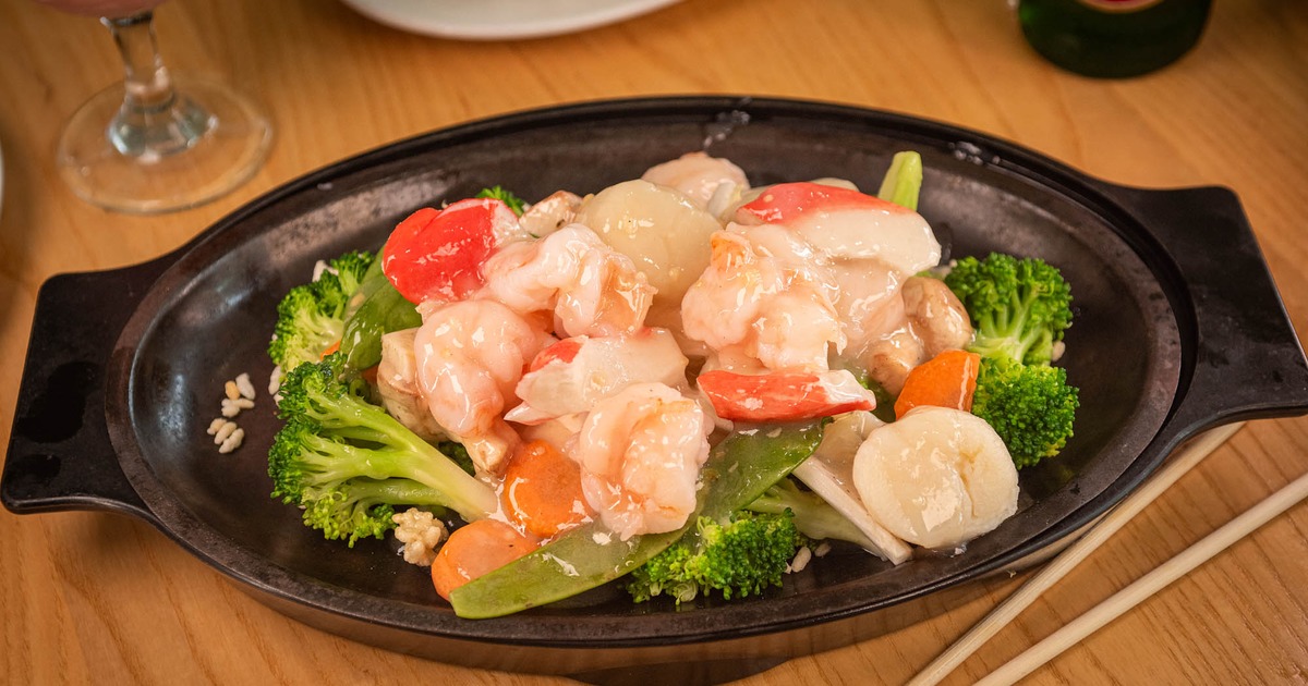 A sizzling platter of seafood and vegetables