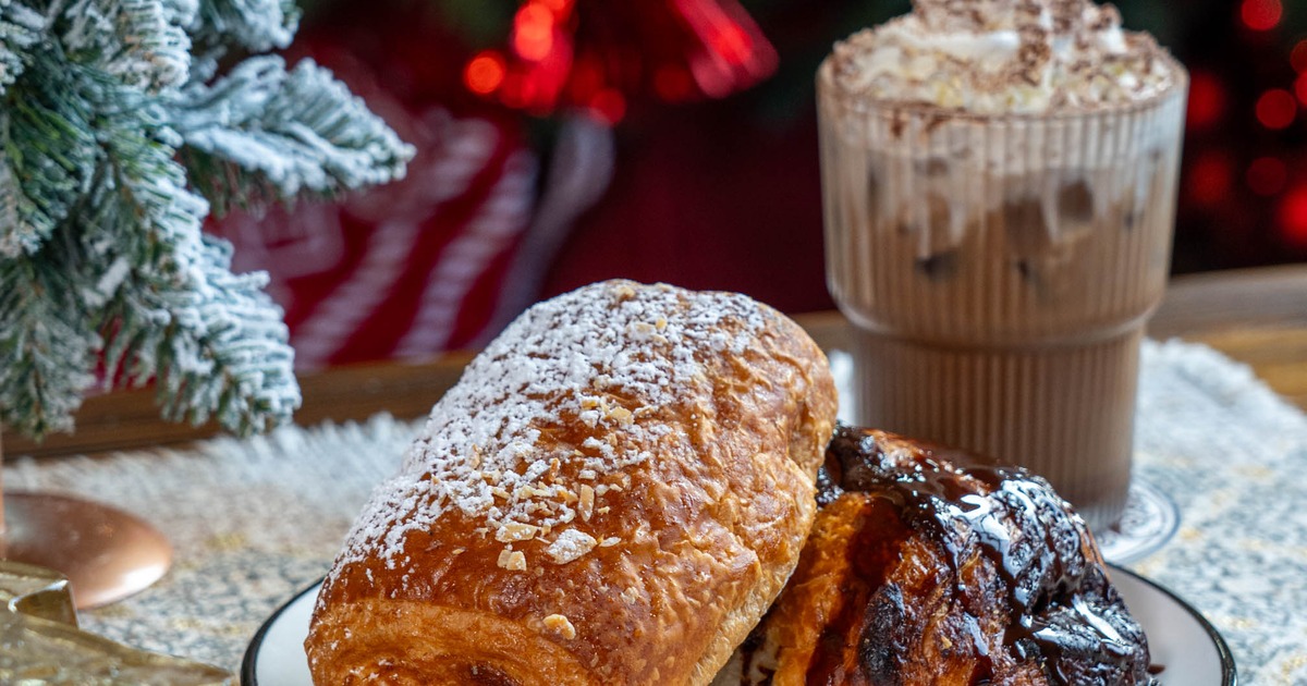 Two types of croissants and Iced coffee topped with whipped cream