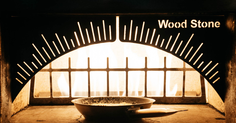 Putting food in the fire oven