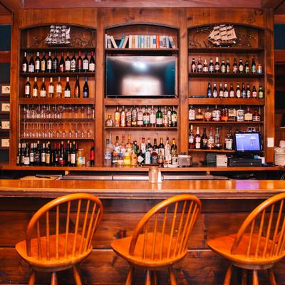 Interior, a bar with bar chairs.