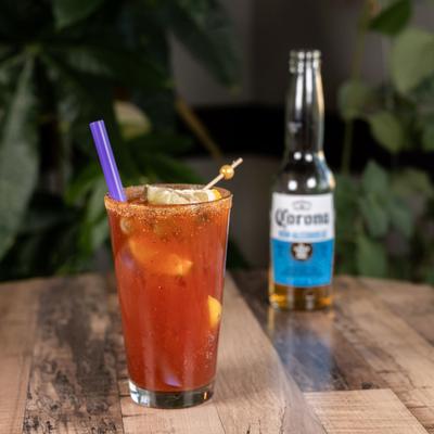 Cajun michelada with bottle of beer in the background.